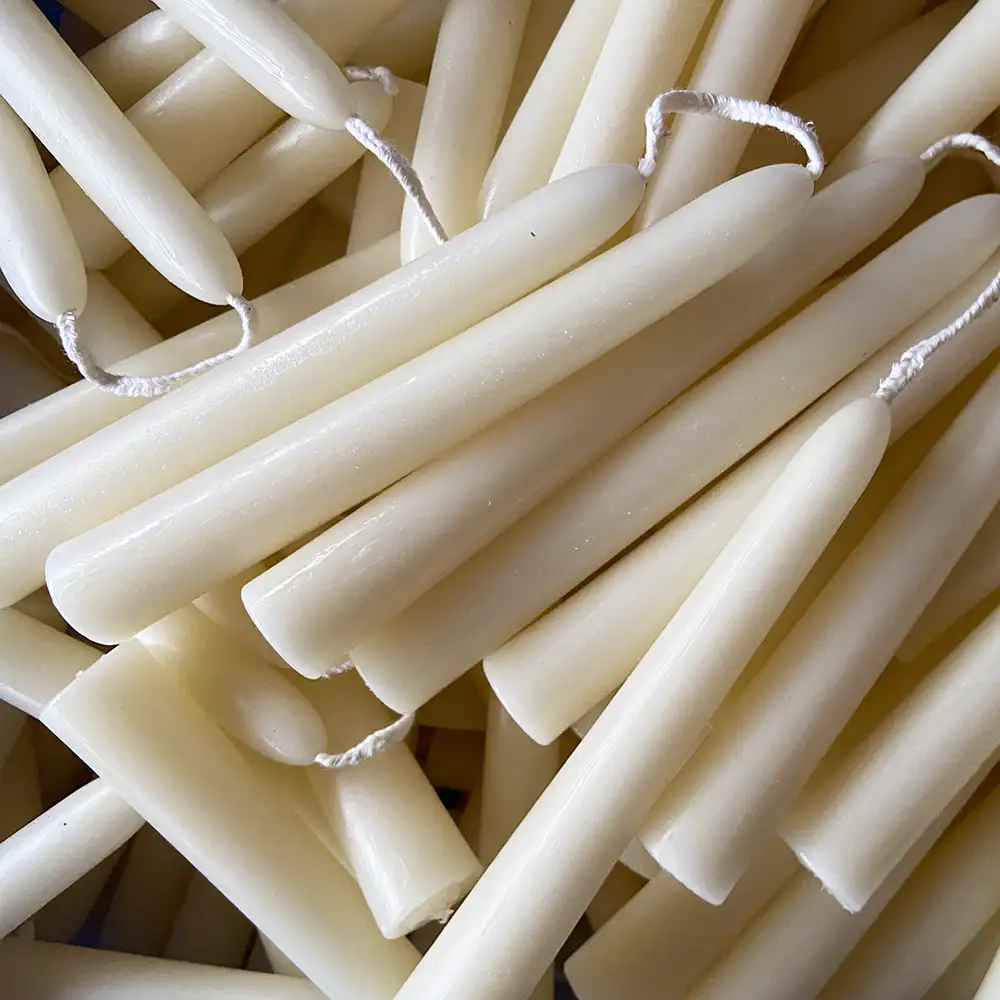 Small conical white beeswax candles
