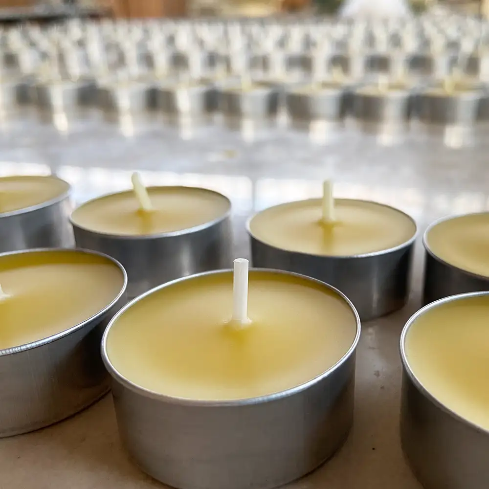 A row of small beeswax tea lights